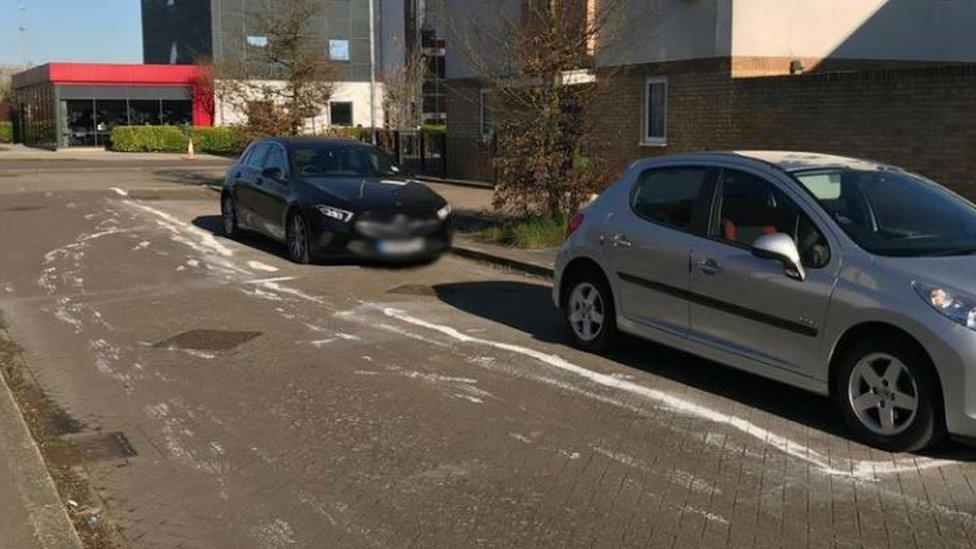 Cars parked in painted white lines