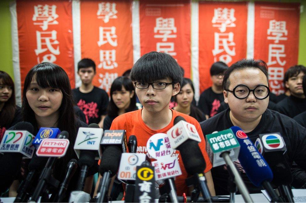 Student protester Joshua Wong (C), 19, and other members of pro-democracy campaign group Scholarism look on at the start of a press conference regarding the group's future plans, in Hong Kong on 20 March 2016