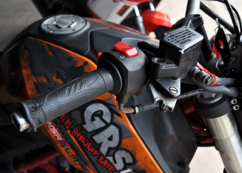 Close up of a motorbike handle and brake