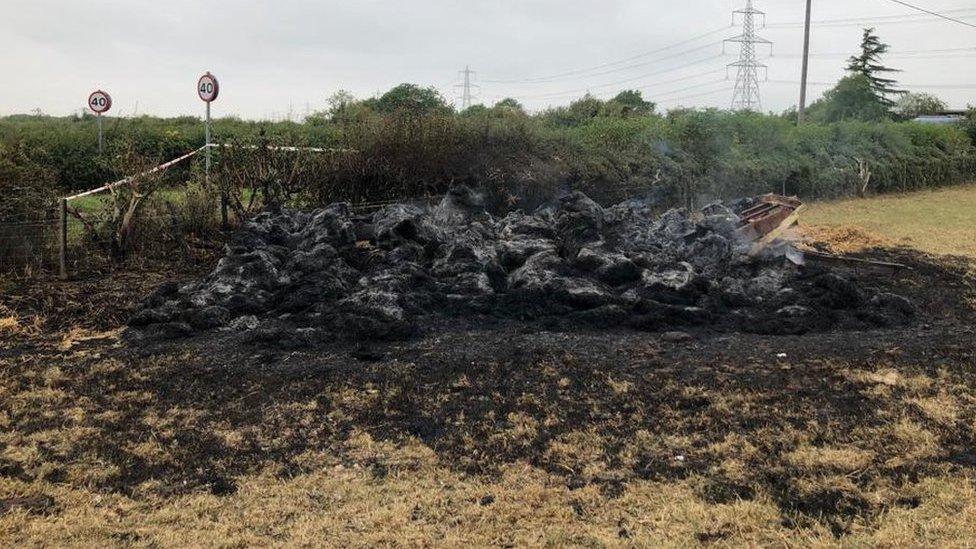 straw bale sculpture destroyed by fire