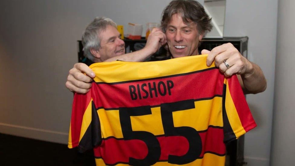 John Bishop is presented with a Partick Thistle shirt