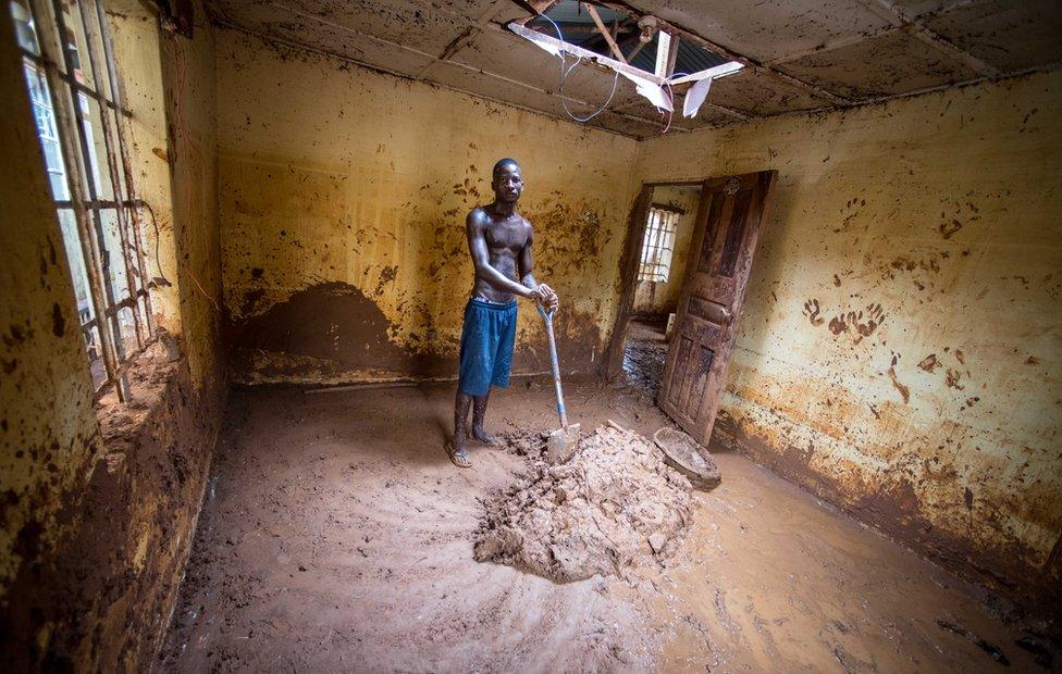 Abdul Mansaray claning his house