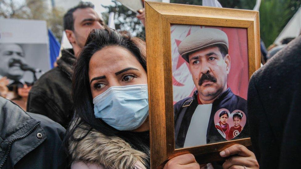 People at a protest in 2022 calling for justice for Chokri Belaid