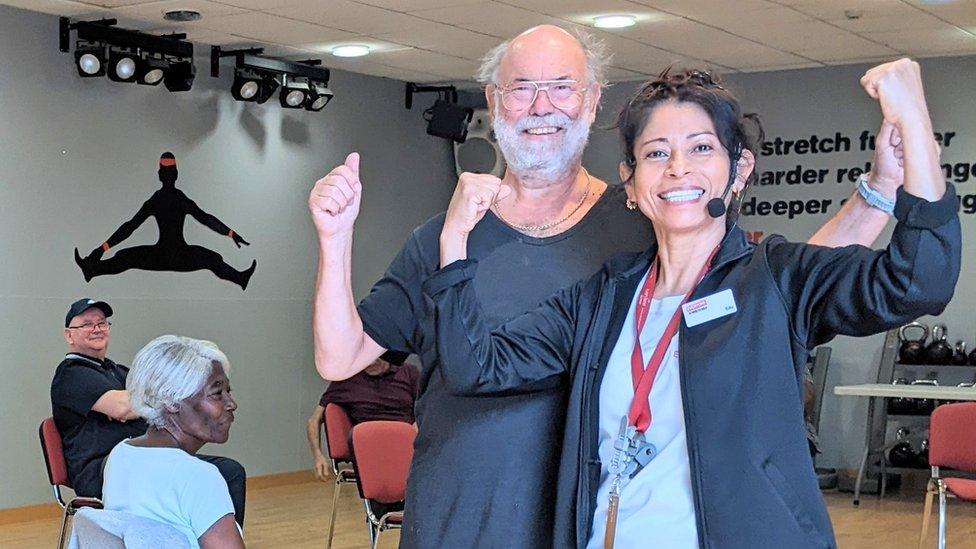 Maurice Ashman and gym instructor Edu Hernandez smiling at the camera