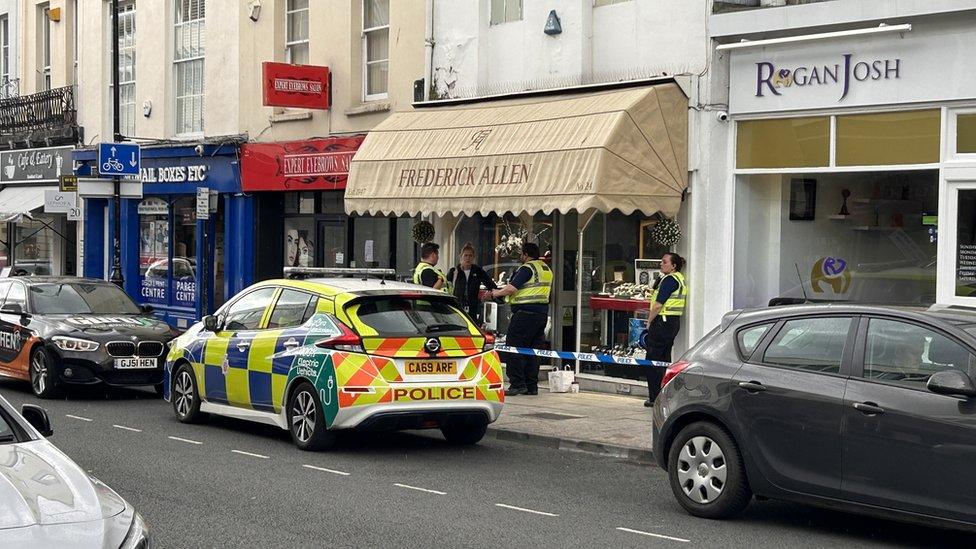 Police stood outside one of the shops which has been robbed