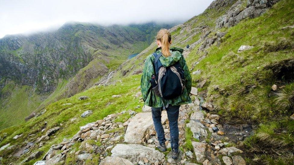 Woman walking down Mount Snowdon