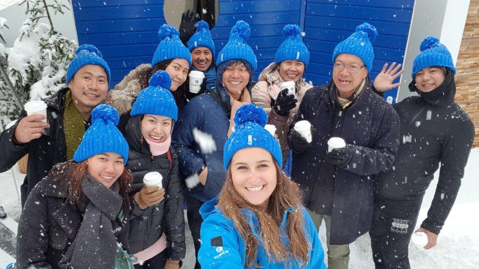 People wearing blue Zurich Insurance bobble hats