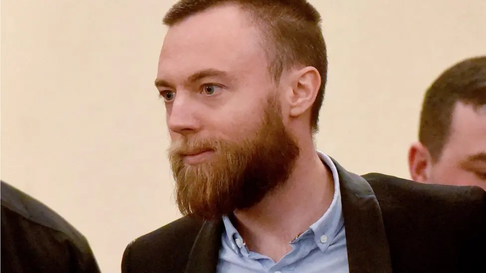 Jack Shepherd in court. He wears a shirt and jacket and has a beard