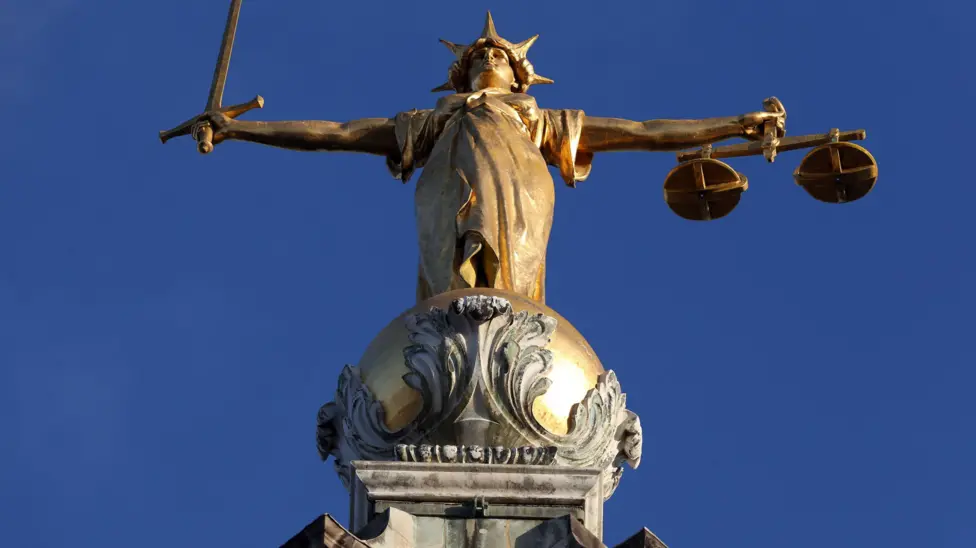 Statue at the top of the Old Bailey