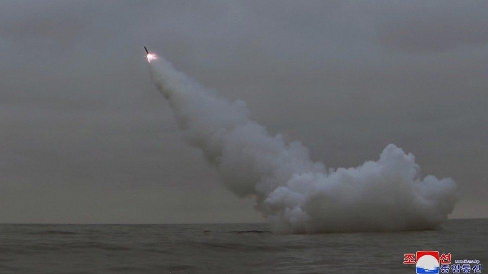 A missile heads towards the sky after being fired from under water