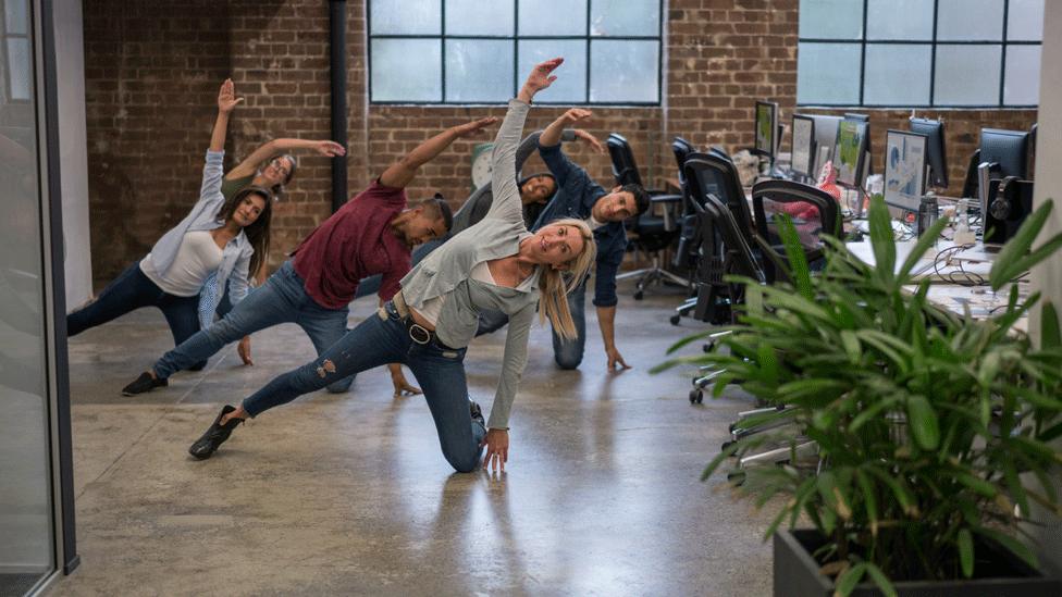 Workers do a work out in the office