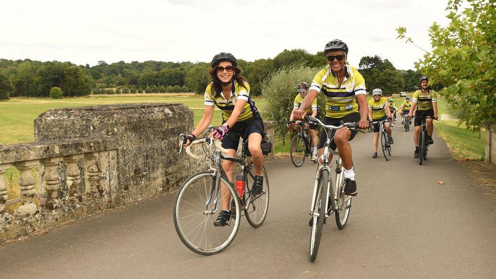 Cyclists smiling on their bikes