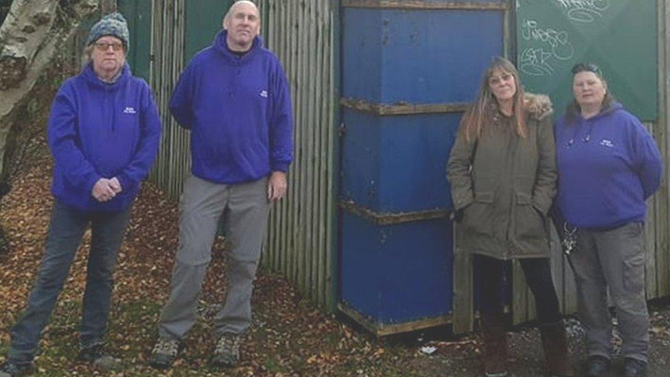 Some of the workers at Meriden Adventure Playground stand outside the storage unit in which toys and clothing was stolen