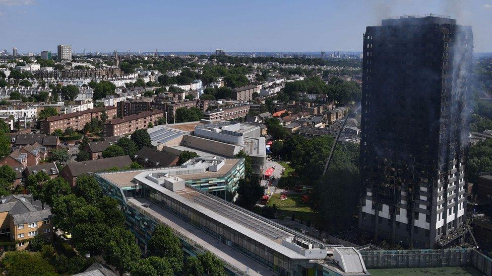 Grenfell Tower smoulders after a fire ripped through the building in west London on June 14,