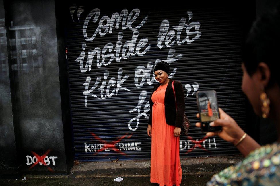 Worshippers take photos outside the House of Praise church