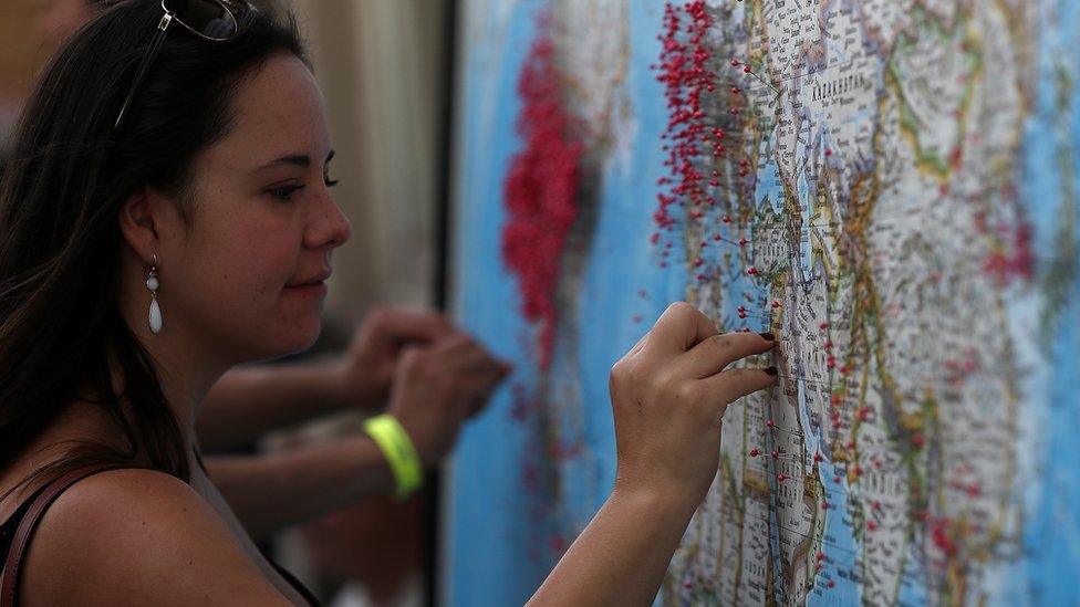 A visitor puts a pin on map to show where she is visiting from during the Wyoming Eclipse Festival on August 20, 2017 in Casper, Wyoming. Thousands of people have descended on Casper, Wyoming to see the solar eclipse in the path of totality as it passes over the state on August 21.