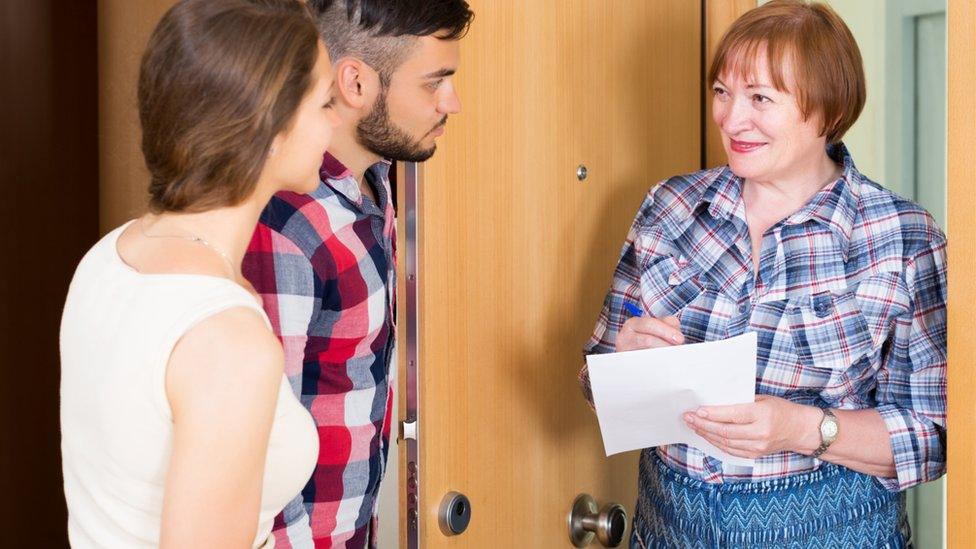 Woman talking to young couple