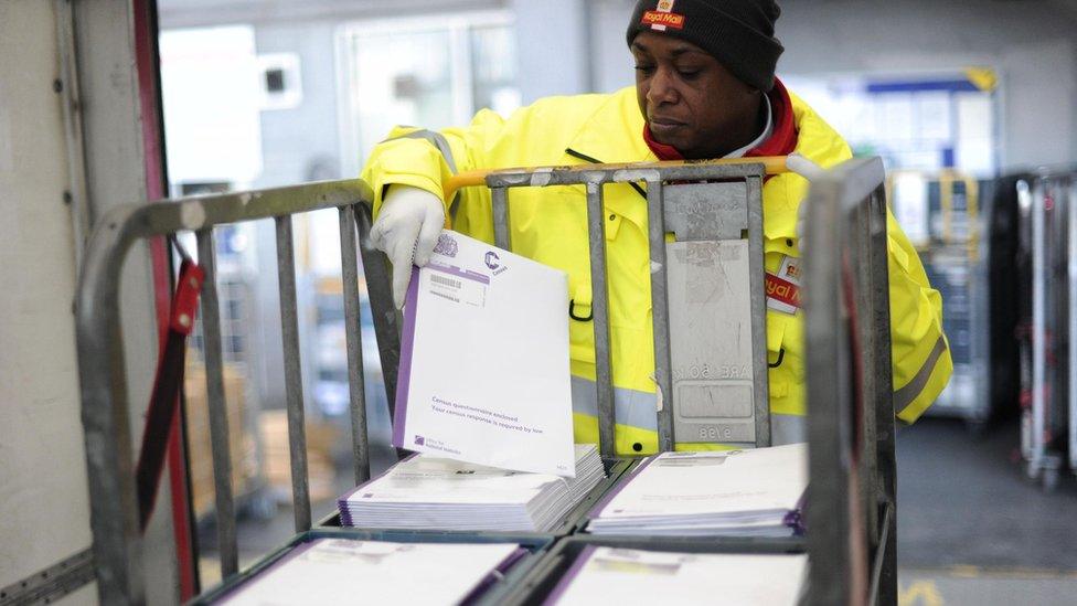 Postman Adrian Alleyne loads a truck with 2011 Census questionnaires at the Mount Pleasant Mail Centre in London ahead of one of the biggest single mailouts the Royal Mail has handled as Census questionnaires will begin dropping through people's letterboxes from tomorrow.