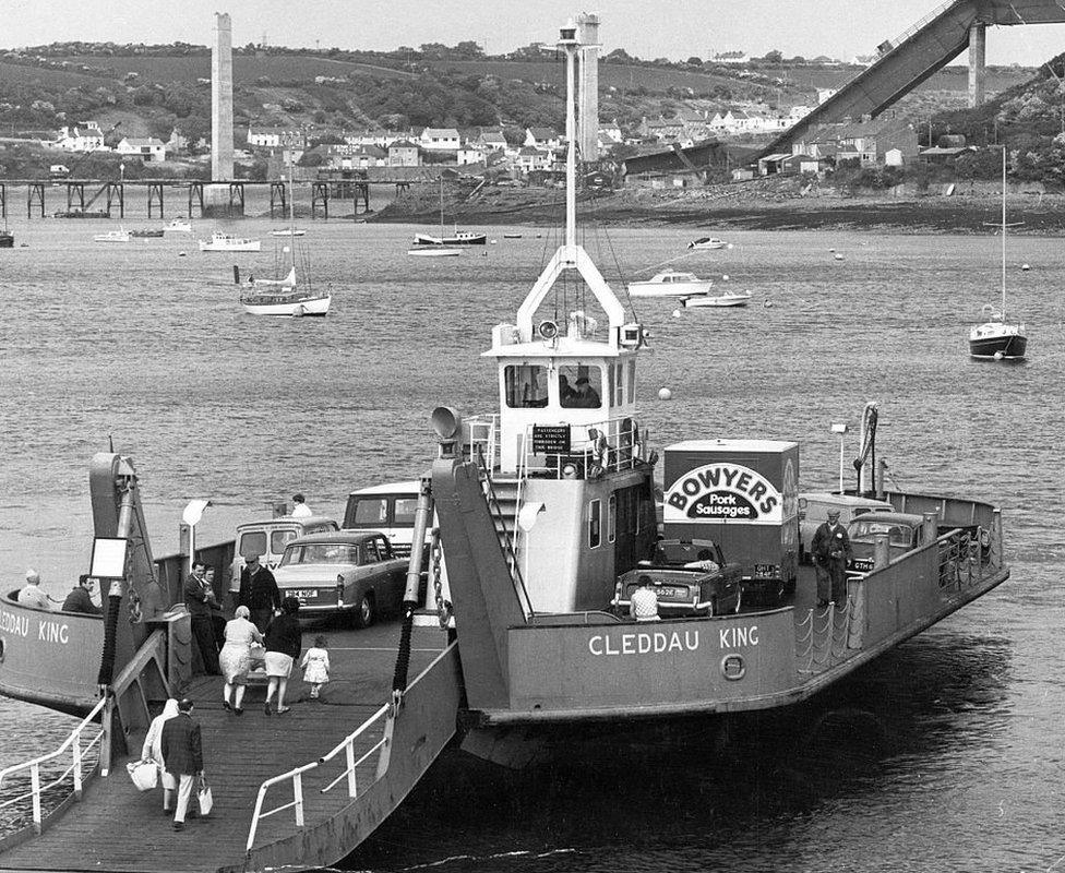 ferry in front of collapsed bridge