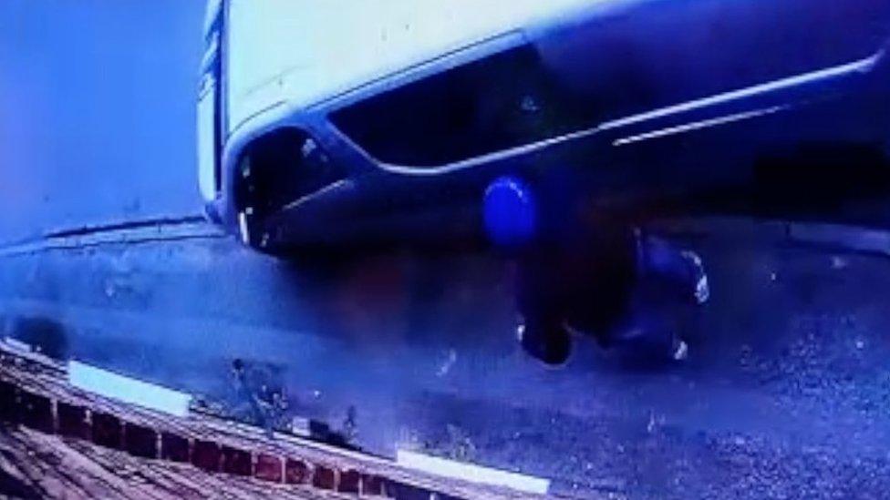 CCTV still of van mounting pavement next to pedestrian