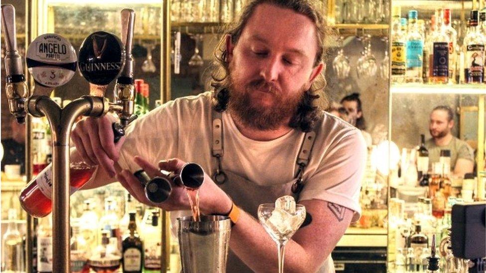 Calum O'Flynn serving a cocktail