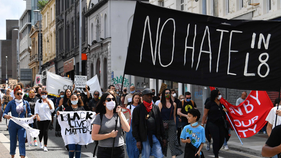 Demonstrators hold No hate in L8 banner