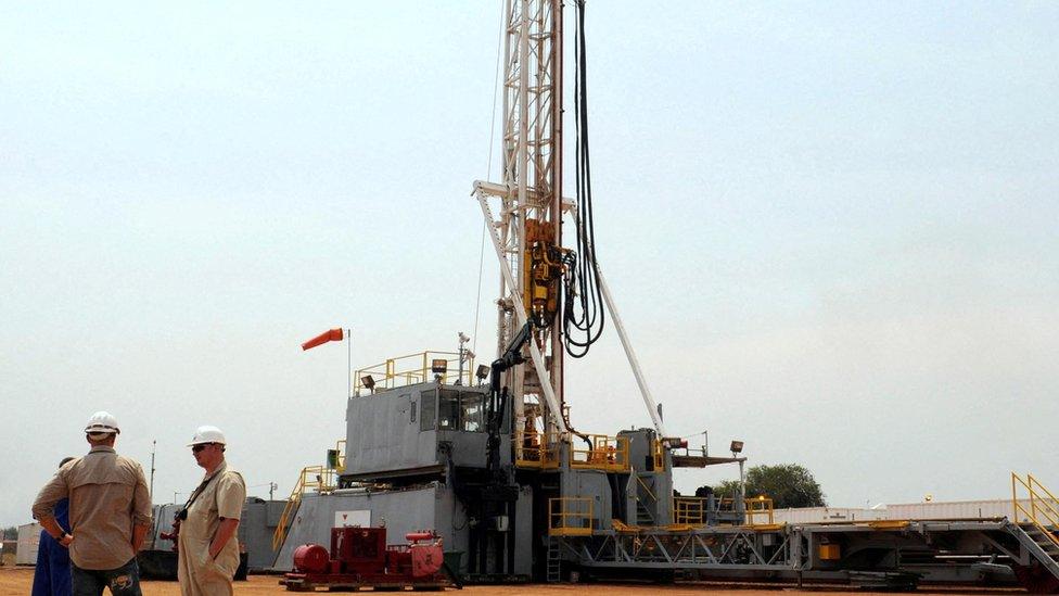 Workers are seen at an oil exploration site in Bulisa district approximately 244km (152 miles) North-West of Kampala January 20, 2012.