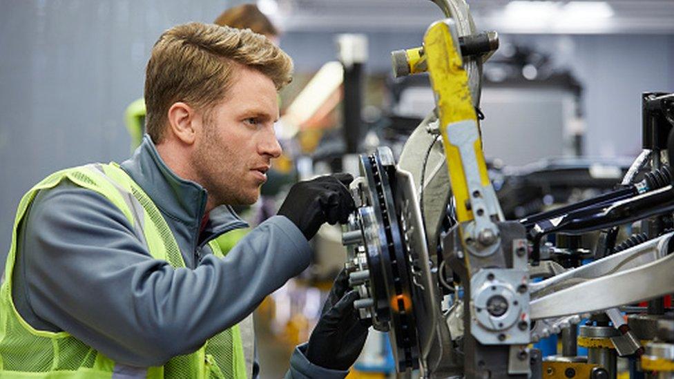 A man working on car part in factory