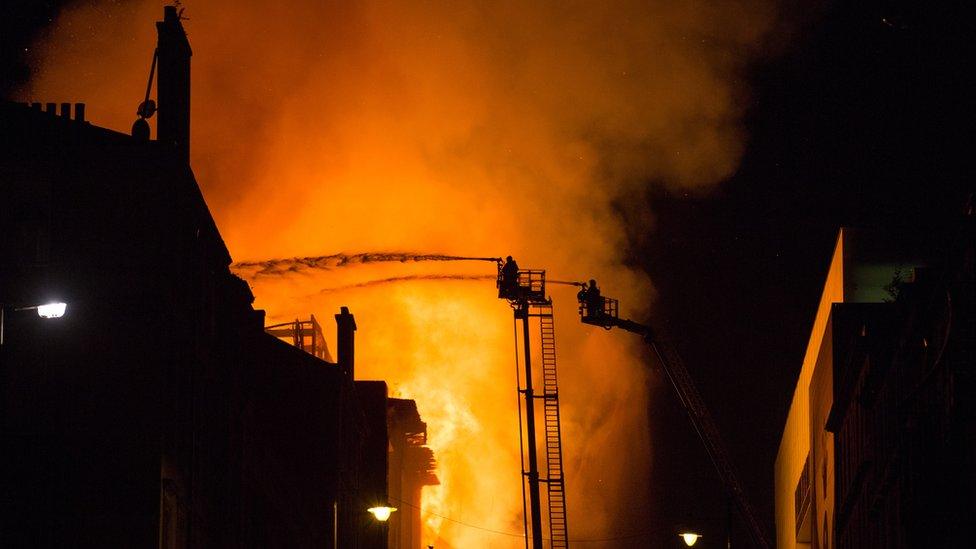 Fire-fighter putting out the fire at the Art school