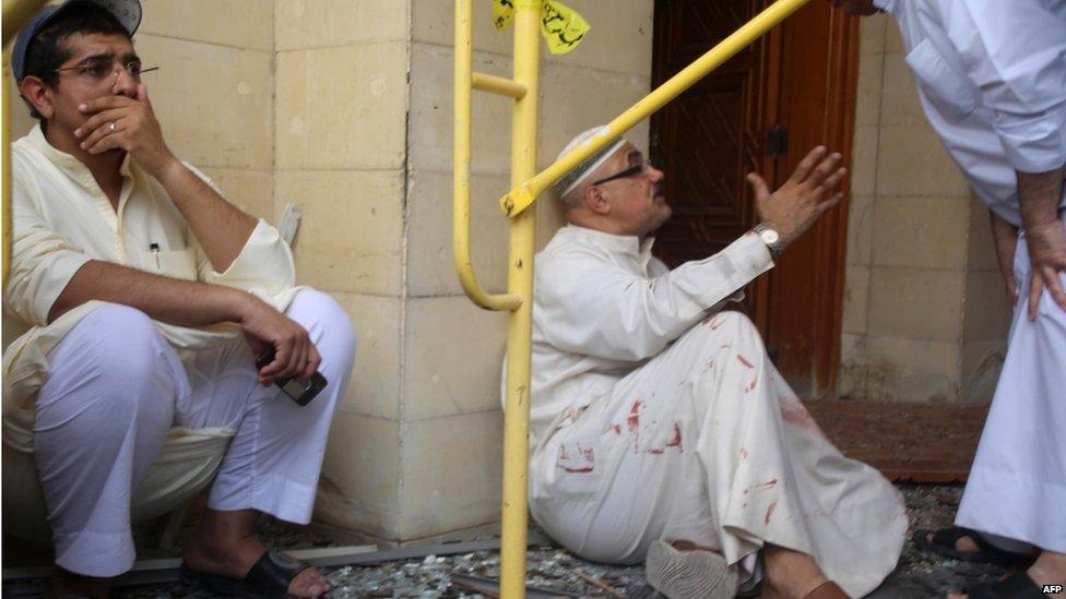 Kuwaiti men react at the site of a suicide bombing that targeted the Shia Al-Imam al-Sadeq mosque during Friday prayers on 26 June 2015, in Kuwait City