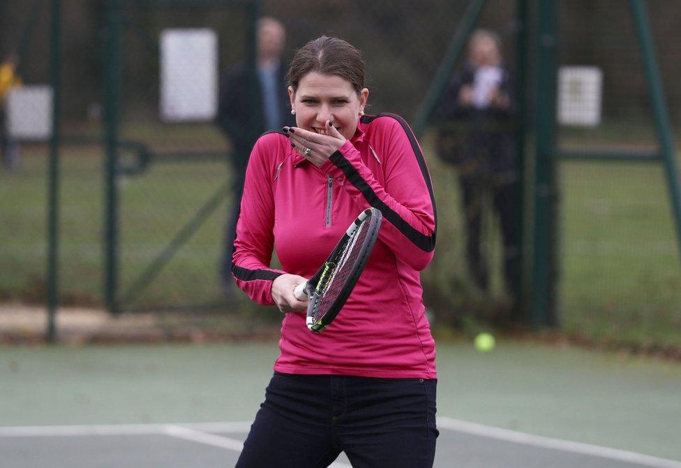 Jo Swinson with a tennis racket