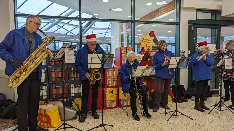 Members of the bands carolling