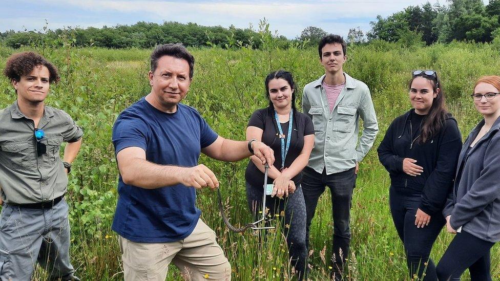 Dr Jones and his students with a snake