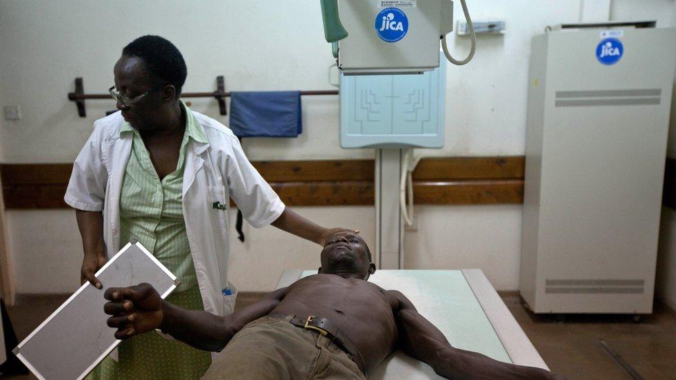 Kenyan doctor treats a patient in hospital