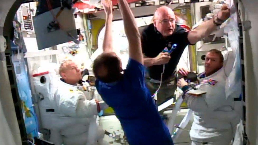 Mission commander Scott Kelly (2nd R) oversees the return of astronauts Tim Peake (R) of Britain and Tim Kopra of the U.S. after their spacewalk outside the International Space Station was ended early January 15, 2015.