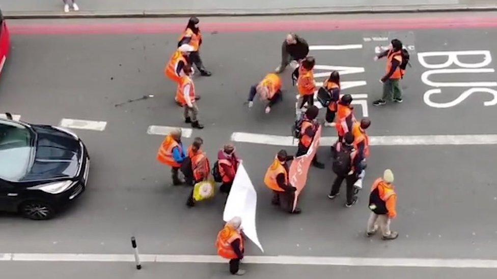 A man pushed a Just Stop Oil protester to the ground