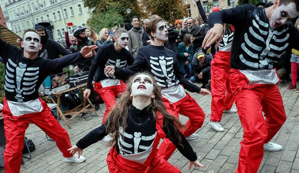 Participants dressed as zombies take part in a Zombie Walk parade