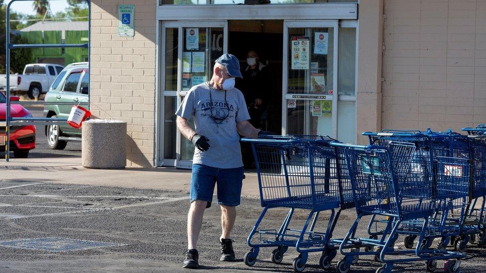 A customer at a grocery store in Arizona wears a mask