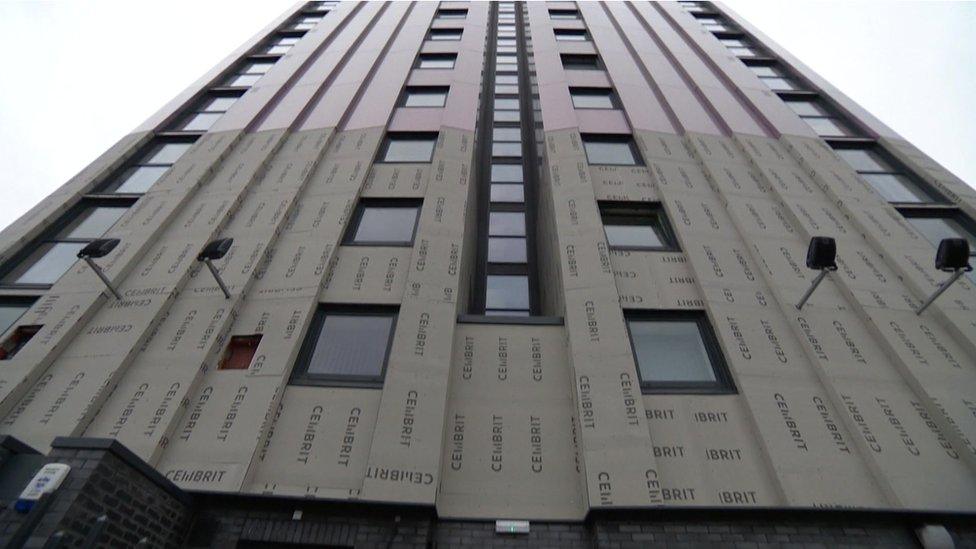 A tower block in Salford where some of the unsafe cladding has been removed