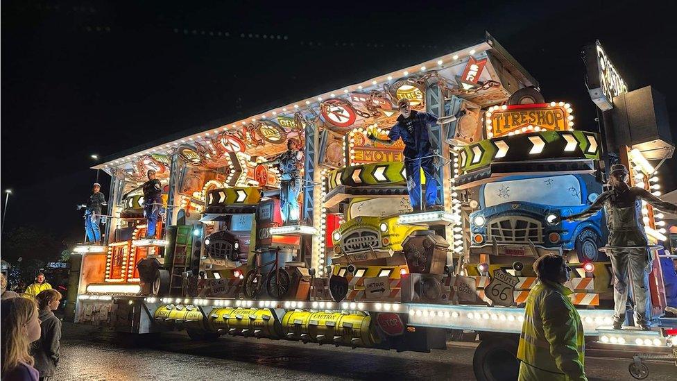 A large carnival float with flashing lights