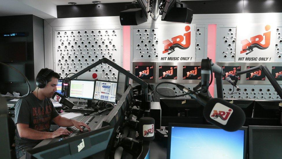 A DJ on air at French radio station NRJ