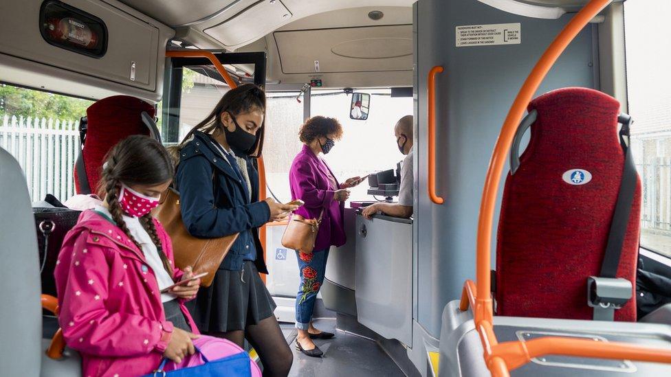 Masked passengers on bus