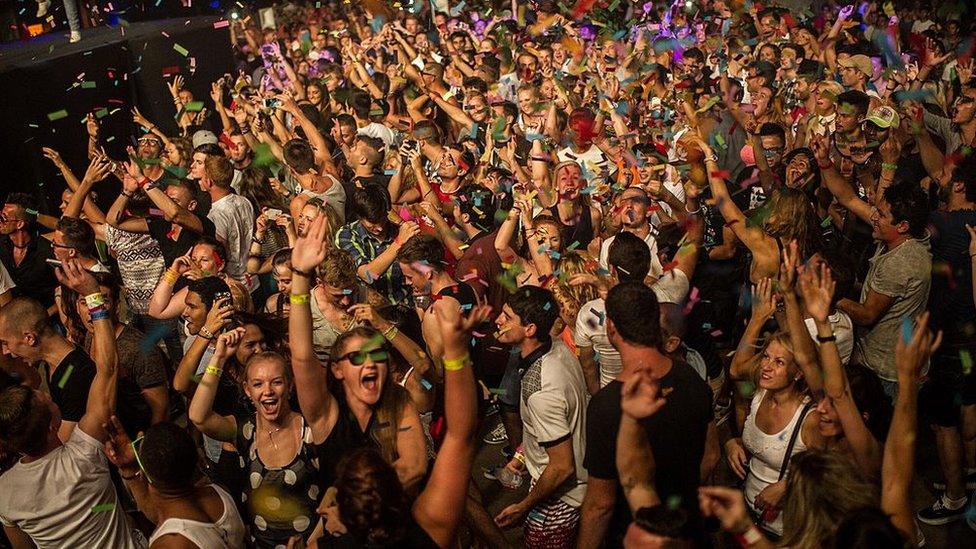 Crowds dancing at a club in Ibiza