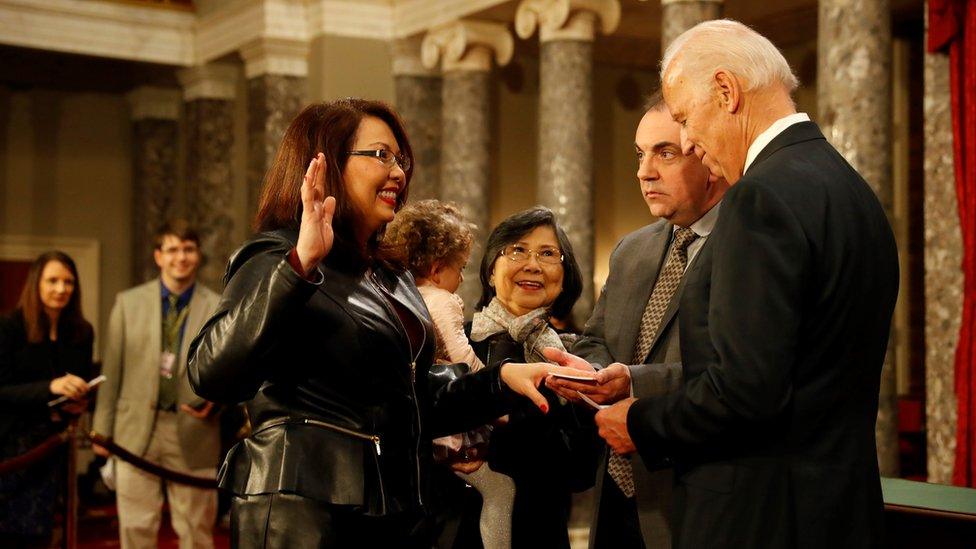 U.S. Sen. Tammy Duckworth (D-IL) participates in a reenacted swearing-in with U.S. Vice President Joe Biden