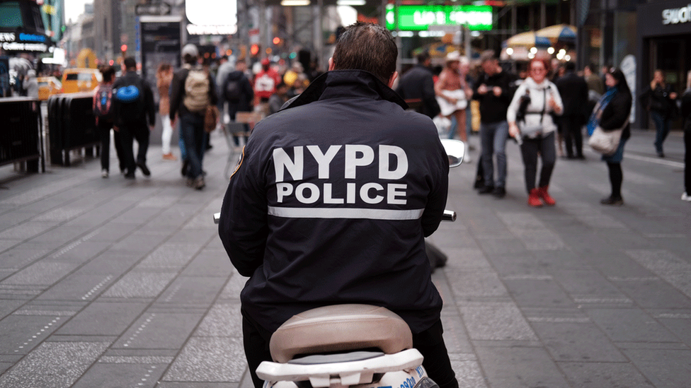 The back of a New York City Police officer on a motorbike