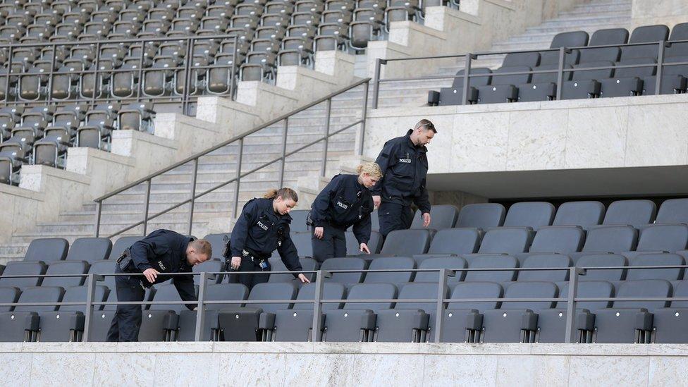 Officers inspect stadium before the match