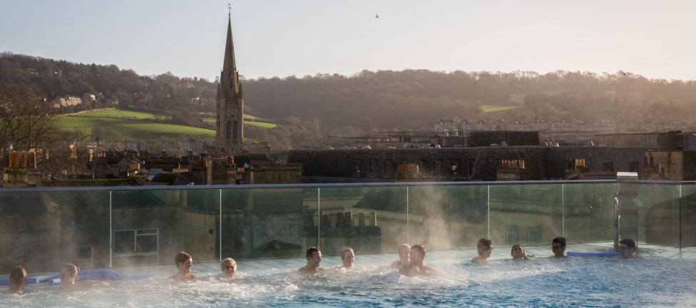 Bathers enjoying balmy weather as they bathe in Thermae Bath Spa