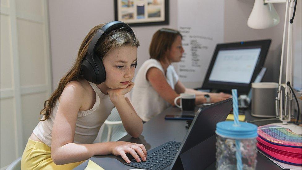 A girl works on a laptop