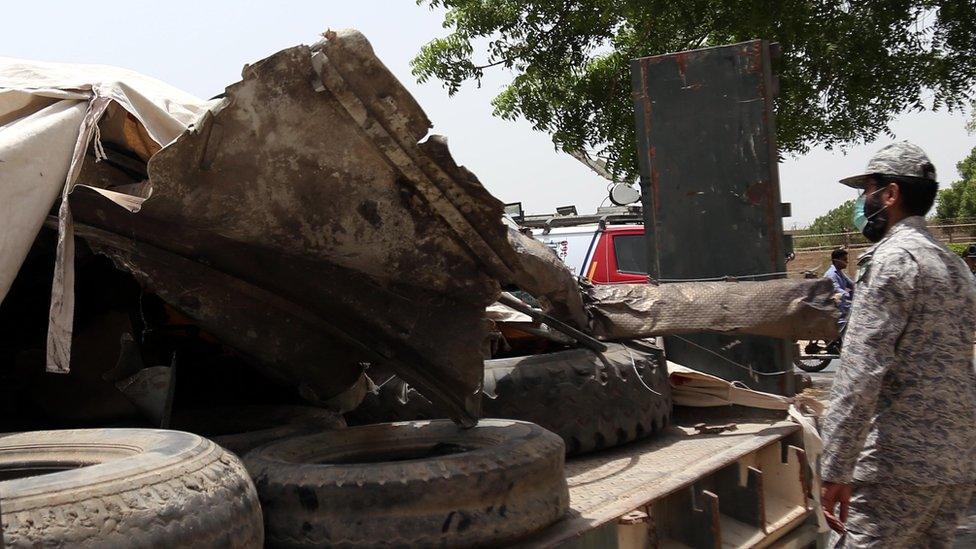 Authorities shift the wreckage of the plane