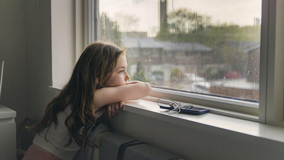 Girl looking out a window